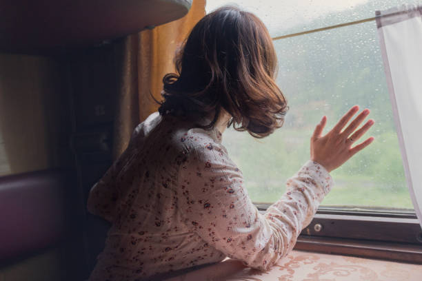 istock Pensive girl at the train window. A train 844526716