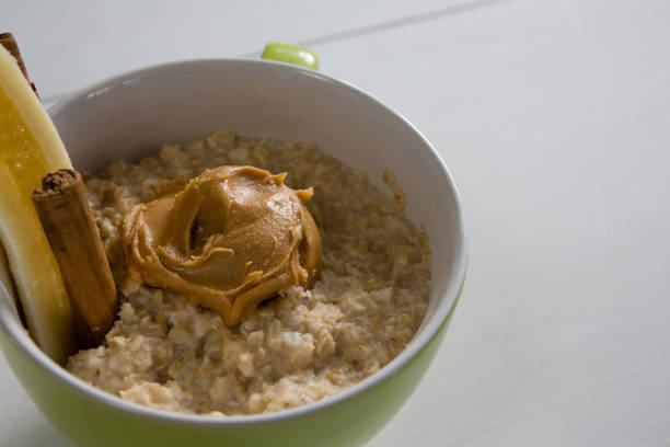 istock Cup of oats with peanut butter and cinnamon sticks 844536530