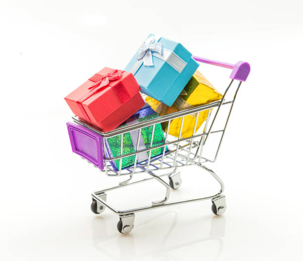 istock Gift boxes in miniature shopping cart on white background. 844537550