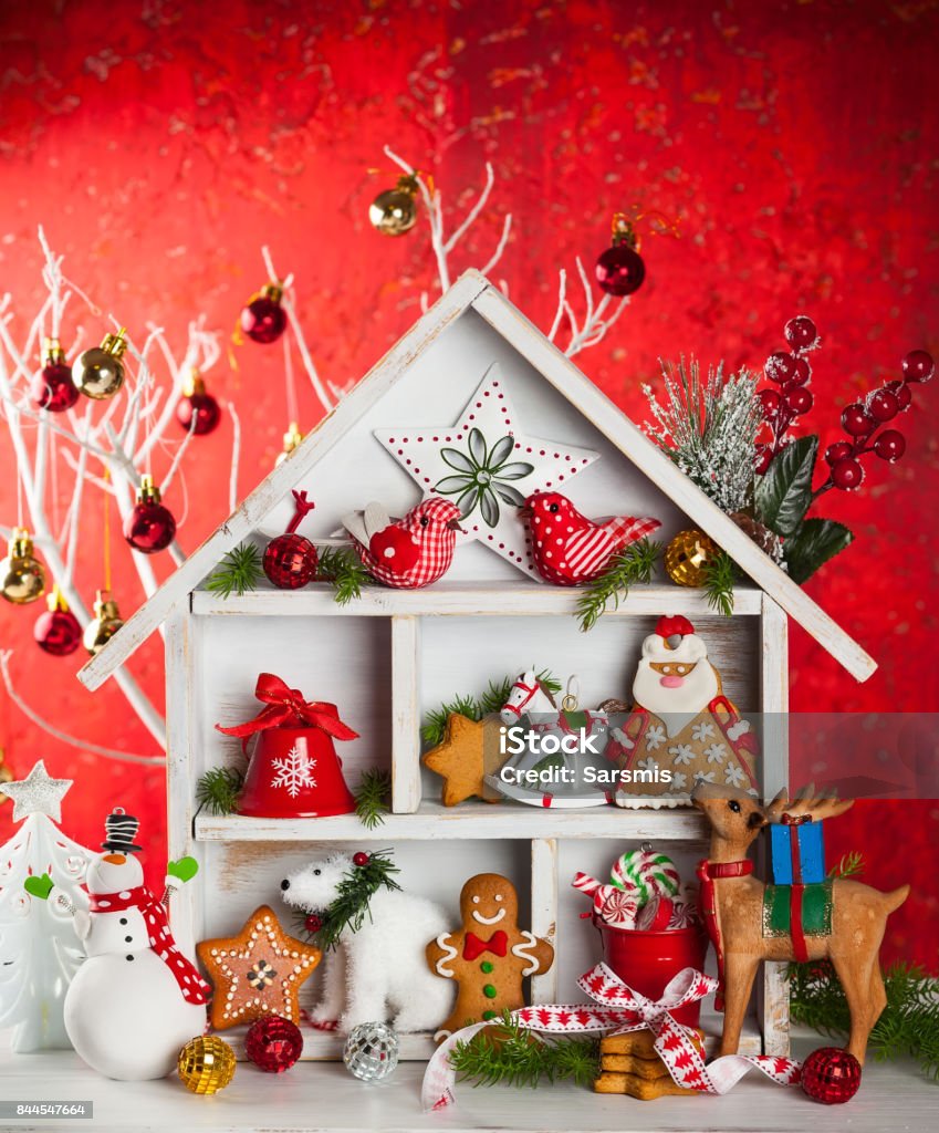 christmas Christmas scene with white wooden house, presents, cookies, snowman and deers Advent Stock Photo