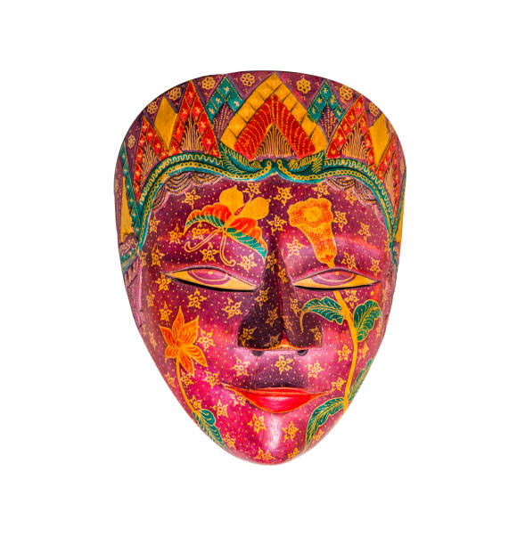 Close-up of masquerade masks with candles on wood background