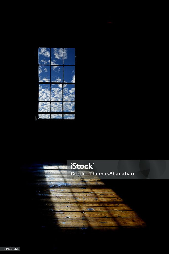 Window filled with Clouds casting Shadow on Floor A cloud filled window casts light and shadow on old wooden floor. Hope - Concept Stock Photo