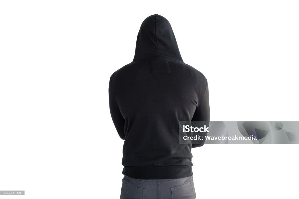 Man standing against white background Rear view of man standing against white background Hooded Shirt Stock Photo