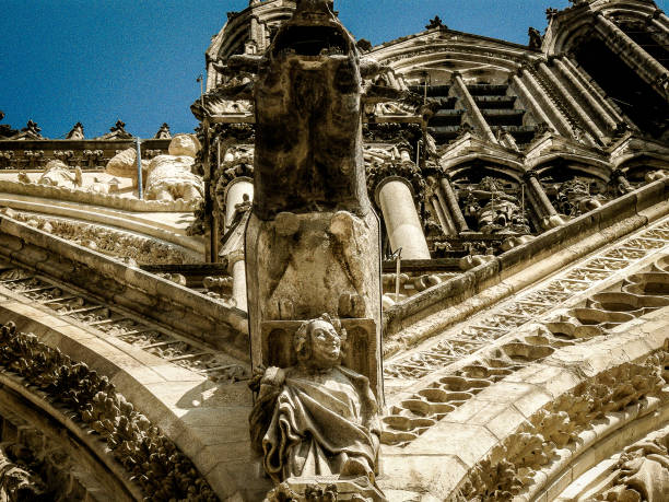 Close up of unusual gargoyle on front of Reims Cathedral taken in Reims, Burgundy, France on 29 June 2018