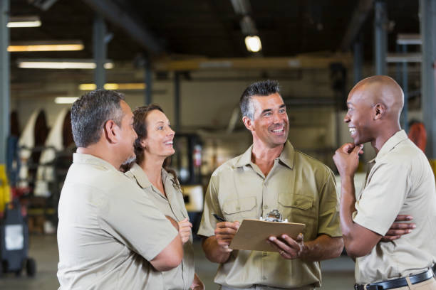 istock Four trucking company workers in garage 844594612