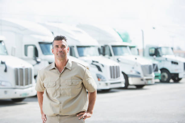 istock Mature man standing in front of semi-trucks 844596900