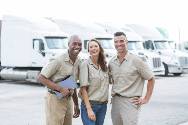 três trabalhadores multi-étnica na frente de caminhões - truck driver multi ethnic group industry working class - fotografias e filmes do acervo