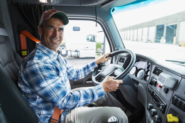 istock Mature man driving a truck outside warehouse 844597358