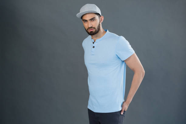 istock Handsome man posing with hands in pocket against grey background 844607928