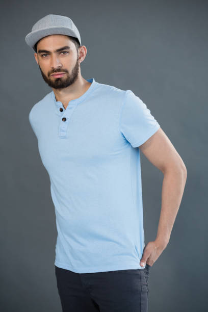 istock Handsome man posing with hands in pocket against grey background 844608008