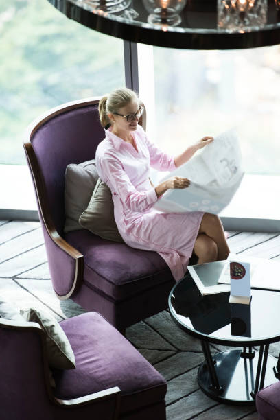 istock Businesswoman reading newspaper 844616836