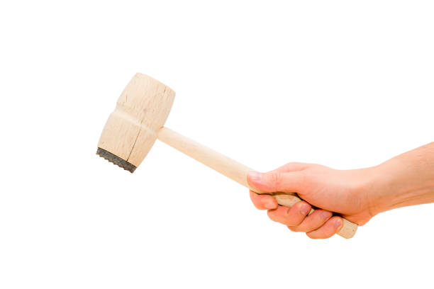 istock Hand holding wooden hammer in action. 844625746