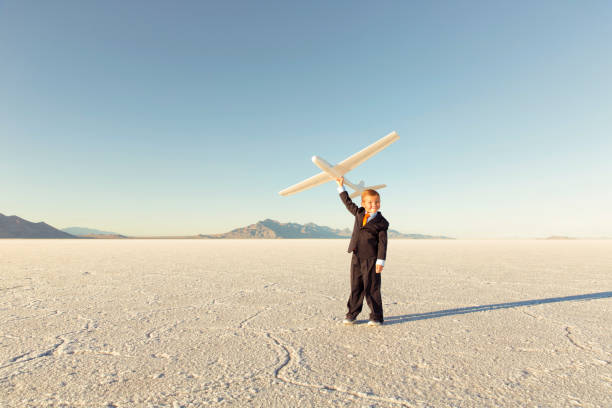 istock Young Business Boy Holding Toy Airplane 844638662