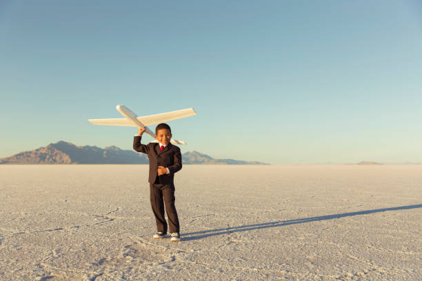 istock Young Business Boy Holding Toy Airplane 844638700