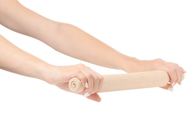 istock Female hand holding a kitchen rolling pin isolated 844644536