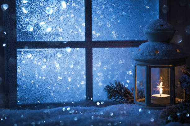 istock Winter decoration with a candlestick near the snow-covered window 844650132
