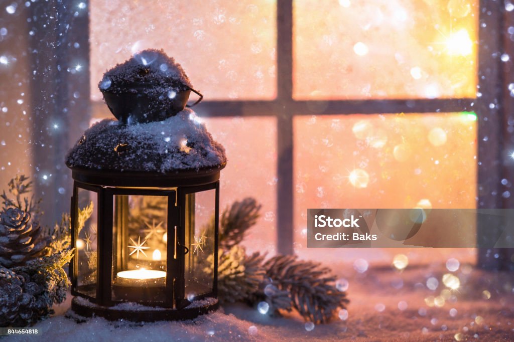 Winter decoration with a candlestick near the snow-covered window Winter decoration with a candlestick near the snow-covered window. Christmas background Christmas Stock Photo