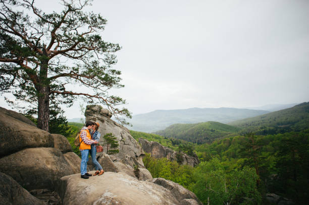 istock traveler couple in casual clothes gently hugging while standing near tree 844661926