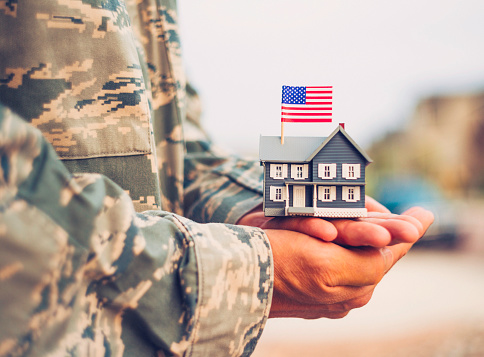 American military soldier with house. Relocation theme
