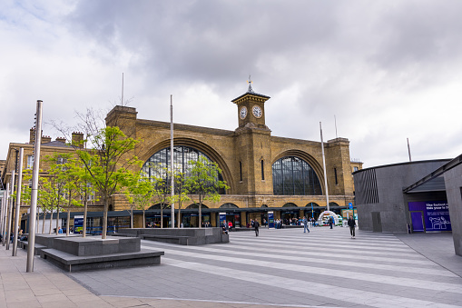 Front view of Kings Cross Station with pedestrian square in the the foreground