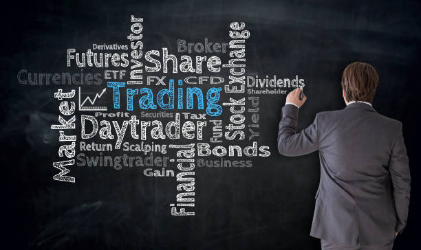 istock Businessman writes trading cloud on blackboard concept 844693194