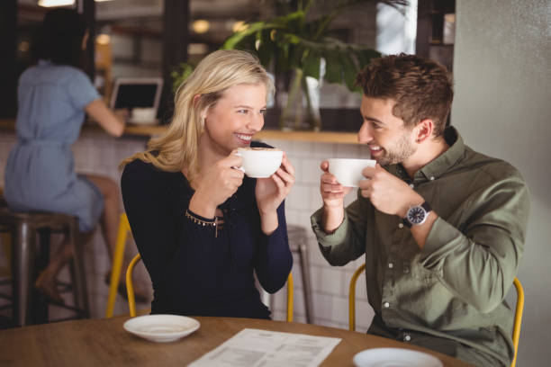 istock Cheerful couple drinking coffee at cafe 844693754