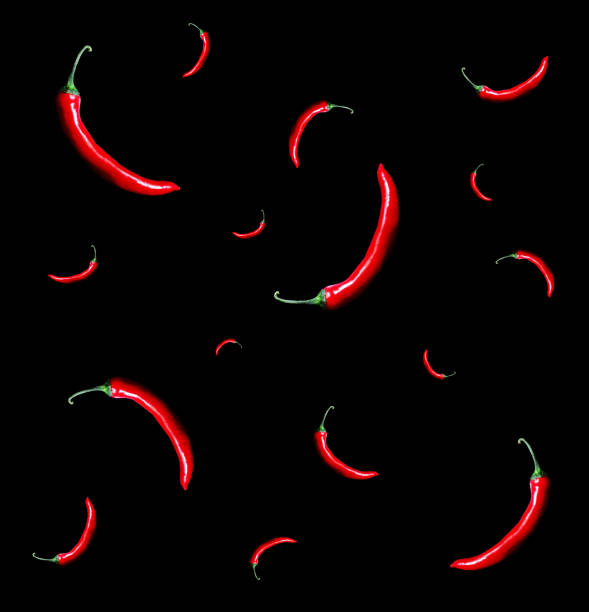 Red chili peppers on black Red chili peppers pattern on black background chili pepper pattern stock pictures, royalty-free photos & images