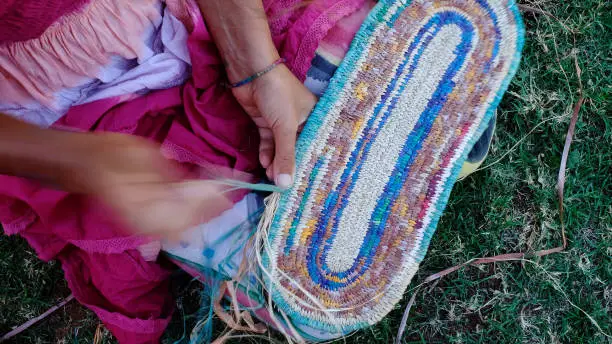 Australian Indigenous Woman Weaving a basket