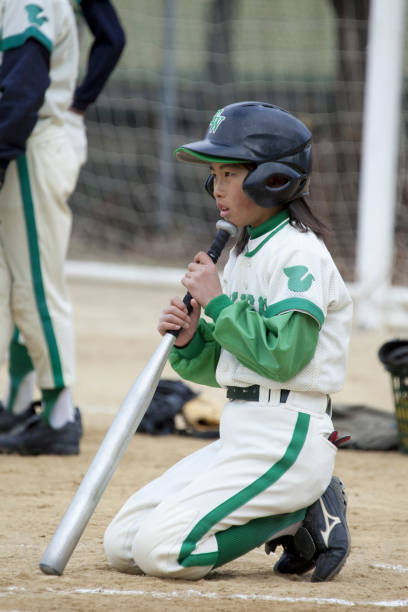 istock The little girl baseball batting 844726260