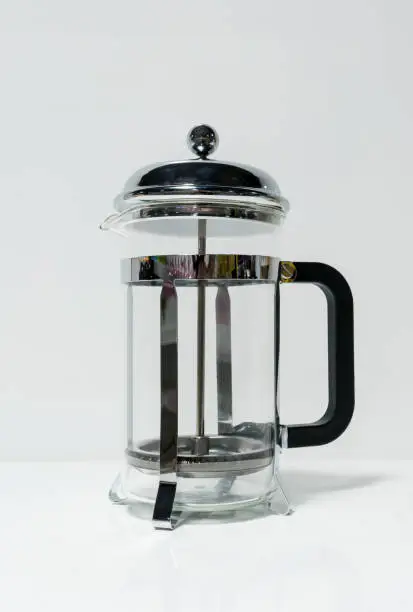 Photo of French press coffee maker with black handle isolated on white