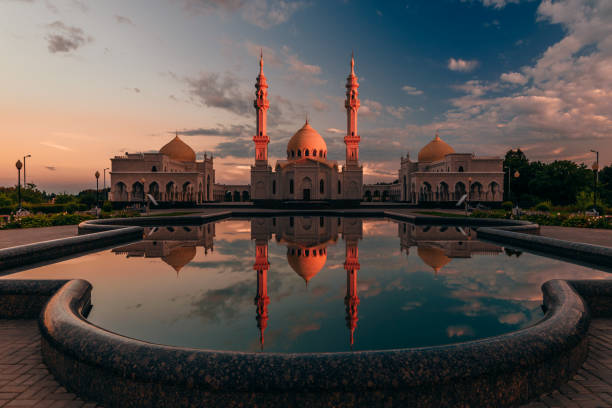 istock Beautiful White Mosque with Reflection on Water at Sunset Light 844731958