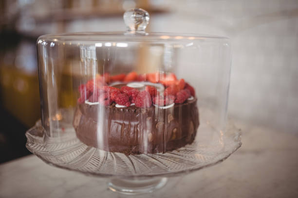 istock Close up of fresh raspberry cake in glass container on table 844750906
