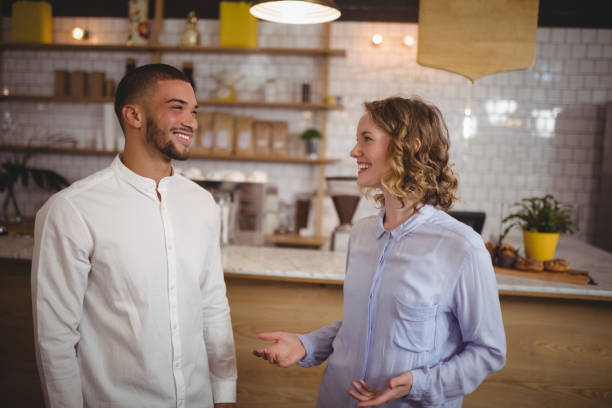 istock Smiling young friends talking at coffee shop 844751208