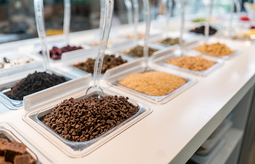 Close-up on the toppings at an ice cream parlor - food and drinks concepts