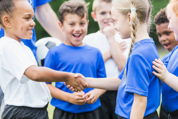istock Children's soccer team, girls shaking hands 844797038