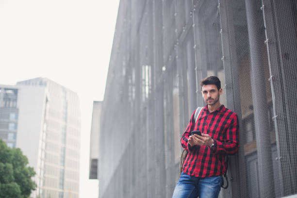 istock Young hipster man typing message on smartphone 844797412