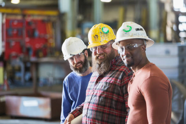 istock Multi-ethnic manual workers in hardhats, safety glasses 844810870