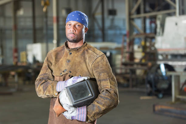 istock African-American man working as welder 844813368