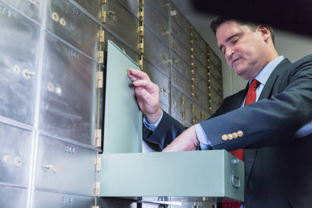 istock Businessman opening a safety deposit box 844817546
