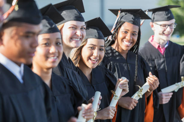 istock Multi-ethnic teenage graduates in cap and gown 844820496