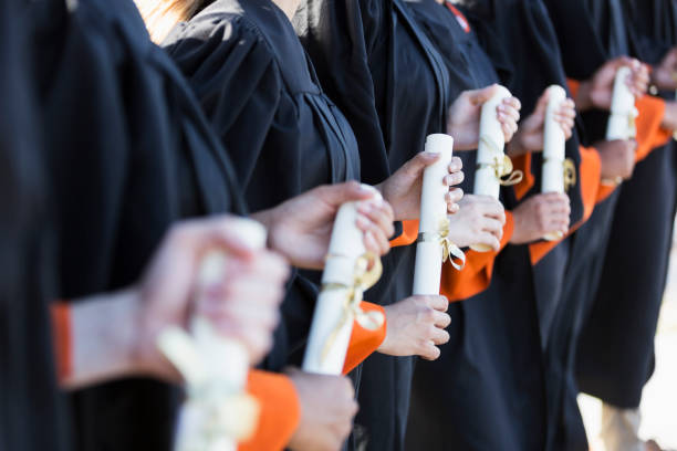 istock Multi-ethnic teenage graduates in cap and gown 844820554