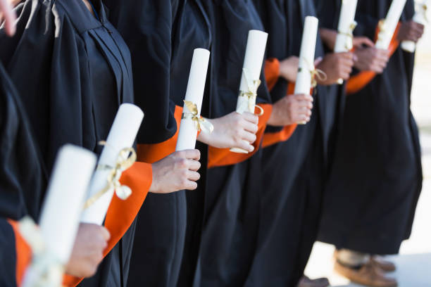 istock Multi-ethnic teenage graduates in cap and gown 844820734