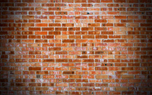 istock Texture of old red brick wall surface with cement and concrete seams 844821410