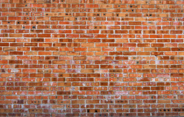 istock Texture of old red brick wall surface with cement and concrete seams 844821414