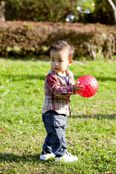 istock The little boy and a red ball 844828338