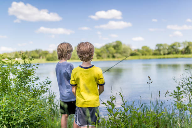 Two boys fishing on the lake