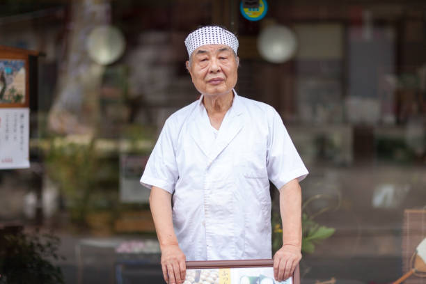Japanese Sweet Master A Japanese sweet (wagashi) master is smiling at the camera,A Japanese sweet (wagashi) master is smiling at the camera,A Japanese sweet (wagashi) master is smiling at the camera,A Japanese sweet (wagashi) master is smiling at the camera, asian-chef stock pictures, royalty-free photos & images