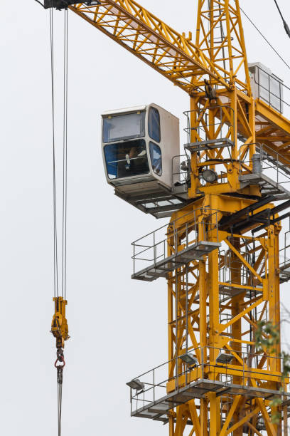 istock Construction crane - yellow metal tower and white cabin - vertical 844905364