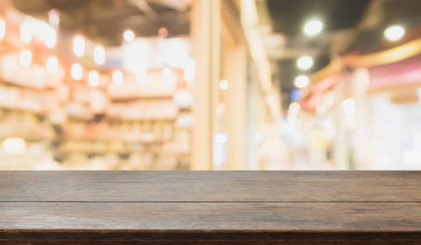 istock Wood table top on blurred with bokeh shopping mall background - can be used for display or montage your products. 844938928