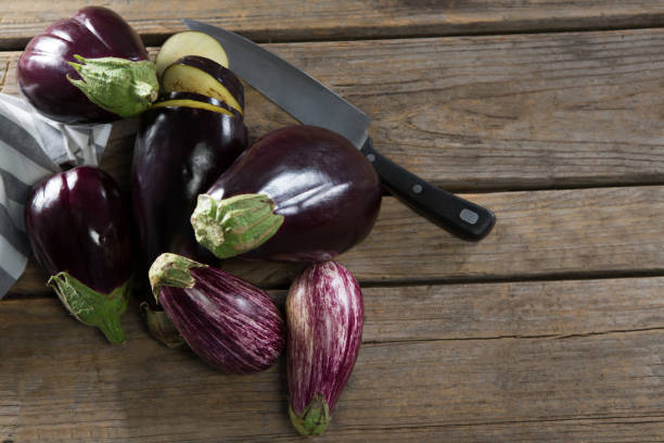 istock Eggplant with knife on wooden table 844942470